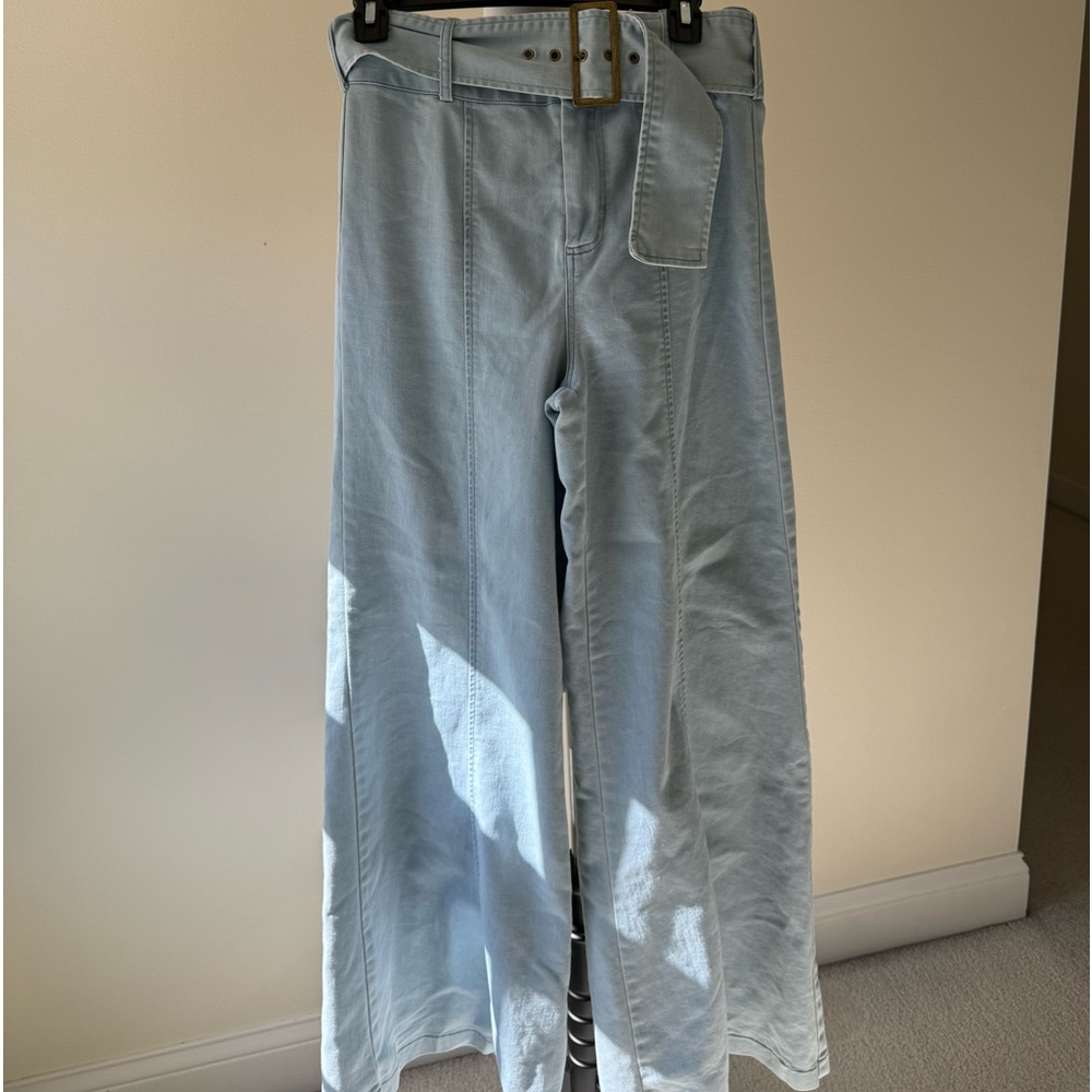 Light blue flare jeans. Worn once. Wide belt. Size medium.
